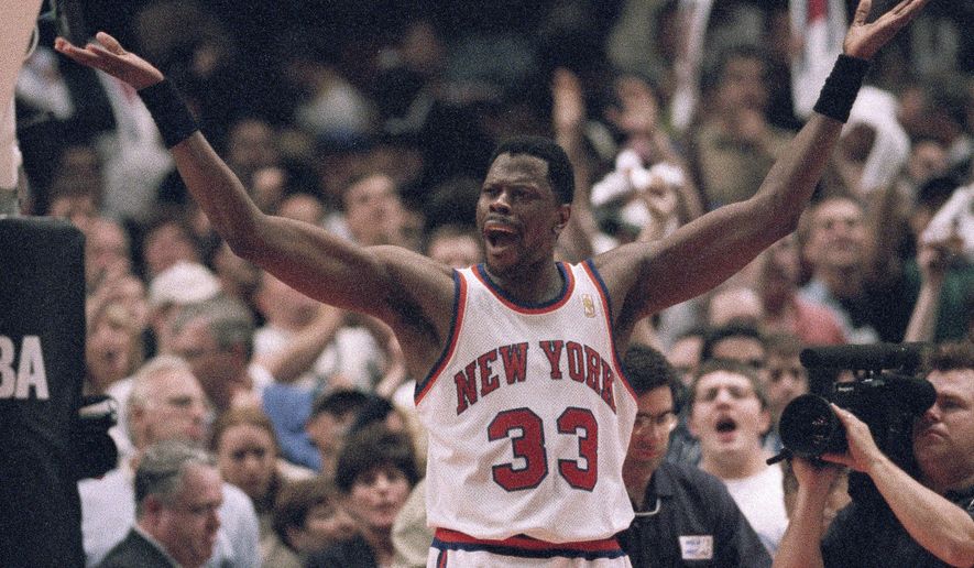 FILE - New York Knicks&#39; Patrick Ewing encourages fans to cheer in the final seconds of their playoff game against the Charlotte Hornets in New York, in this Saturday, April 26, 1997, file photo. The Knicks won 100-93. Patrick Ewing and Georgetown are back in the NCAA Tournament. The 7-footer who helped the Hoyas win one national championship and reach two other finals in the 1980s is now coaching at his alma mater. Georgetown is a No. 12 seed and will play No. 5 Colorado in the East Region on Saturday. (AP Photo/Adam Nadel, File)