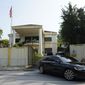 A car goes out of the North Korean Embassy in Kuala Lumpur, Malaysia, Friday, March 19, 2021. North Korea on Friday said it was cutting diplomatic ties with Malaysia to protest a recent court ruling that allows a North Korean citizen to be extradited to the United States to face money laundering charges. (AP Photo/Vincent Thian)
