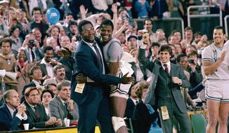 FILE - Georgetown head coach John Thompson, left, gives a happy pat to the most valuable player, Patrick Ewing, after Georgetown defeated Houston in the NCAA college basketball championship game in Seattle, in this April 2, 1984, file photo. Patrick Ewing and Georgetown are back in the NCAA Tournament. The 7-footer who helped the Hoyas win one national championship and reach two other finals in the 1980s is now coaching at his alma mater. Georgetown is a No. 12 seed and will play No. 5 Colorado in the East Region on Saturday, March 20, 2021. (AP Photo/File)