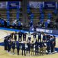 Oral Roberts players and coaches form a prayer circle on the court following their win over Ohio State in a first-round game in the NCAA men&#39;s college basketball tournament, Friday, March 19, 2021, at Mackey Arena in West Lafayette, Ind. (AP Photo/Robert Franklin)