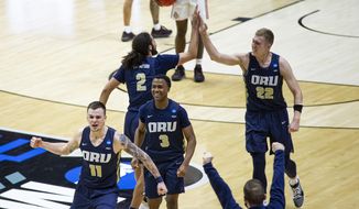 Oral Roberts players celebrate after beating Ohio State in a first-round game in the NCAA men&#39;s college basketball tournament, Friday, March 19, 2021, at Mackey Arena in West Lafayette, Ind. (AP Photo/Robert Franklin)