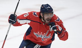 Washington Capitals left wing Alex Ovechkin (8) celebrates his first goal of an NHL hockey game during the third period against the New York Rangers, Friday, March 19, 2021, in Washington. (AP Photo/Nick Wass)