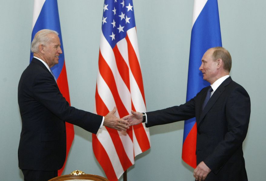 In this March 10, 2011, file photo, then-Vice President of the United States Joe Biden, left, shakes hands with Russian Prime Minister Vladimir Putin in Moscow, Russia. (AP Photo/Alexander Zemlianichenko, File)