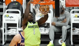 Minnesota Timberwolves forward Anthony Edwards (1) dunks against the Phoenix Suns during the first half of an NBA basketball game Thursday, March 18, 2021, in Phoenix. (AP Photo/Rick Scuteri)