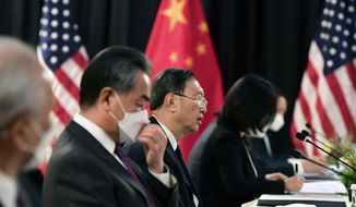 Chinese Communist Party foreign affairs chief Yang Jiechi, center, and China&#39;s State Councilor Wang Yi, second from left, speak at the opening session of US-China talks at the Captain Cook Hotel in Anchorage, Alaska, Thursday, March 18, 2021. (Frederic J. Brown/Pool via AP)