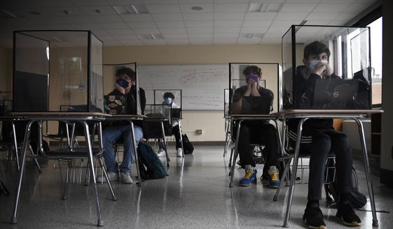 In this March 18, 2021, file photo, students listen to a presentation in a health class in a Connecticut high school. (AP Photo/Jessica Hill, File) **FILE**