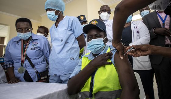 In this March 5, 2021, file photo, a hospital security guard receives one of the country&#39;s first coronavirus vaccinations using AstraZeneca COVID-19 vaccine provided through the global COVAX initiative, at Kenyatta National Hospital in Nairobi, Kenya. The suspension of the AstraZeneca vaccine in several European countries could fuel skepticism about the shot far beyond their shores, potentially threatening the rollout of a vaccine that is key to the global strategy to stamp out the coronavirus pandemic, especially in developing nations. (AP Photo/Ben Curtis, File)
