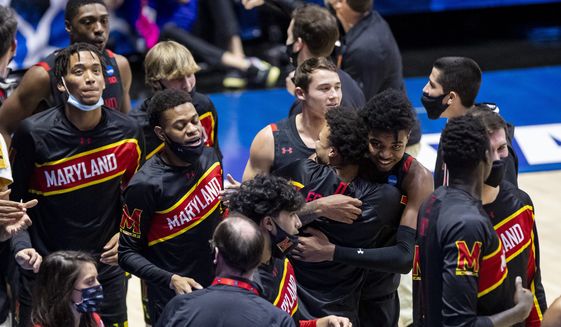 Maryland players gather on the court after defeating Connecticut 63-54 in a first-round game in the NCAA men&#39;s college basketball tournament Saturday, March 20, 2021, at Mackey Arena in West Lafayette, Ind. (AP Photo/Robert Franklin)