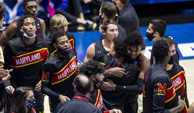 Maryland players gather on the court after defeating Connecticut 63-54 in a first-round game in the NCAA men&#x27;s college basketball tournament Saturday, March 20, 2021, at Mackey Arena in West Lafayette, Ind. (AP Photo/Robert Franklin)