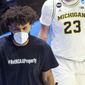 Michigan&#x27;s Isaiah Livers wears a T-shirt that reads &amp;quot;#NotNCAAProperty&amp;quot; as he walks off the court with teammates after the first half of a first-round game against Texas Southern in the NCAA men&#x27;s college basketball tournament, Saturday, March 20, 2021, at Mackey Arena in West Lafayette, Ind. (AP Photo/Robert Franklin)