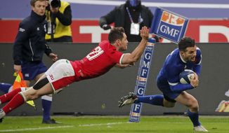 France&#39;s Brice Dulin, right, crosses the line to score the winning try during the Six Nations rugby union international between France and Wales at the Stade de France in Saint-Denis, near Paris, Saturday, March 20, 2021. (AP Photo/Francois Mori)