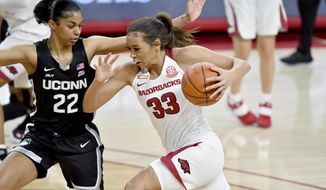 FILE - In this Jan. 28, 2021, file photo, Arkansas guard Chelsea Dungee (33) tries to drive past Connecticut defender Evina Westbrook (22) during the first half of an NCAA college basketball game in Fayetteville, Ark. Led by SEC scoring leader and third-team AP All-American Dungee, the Razorbacks (19-8) are in their first NCAA Tournament since 2015. (AP Photo/Michael Woods, File)