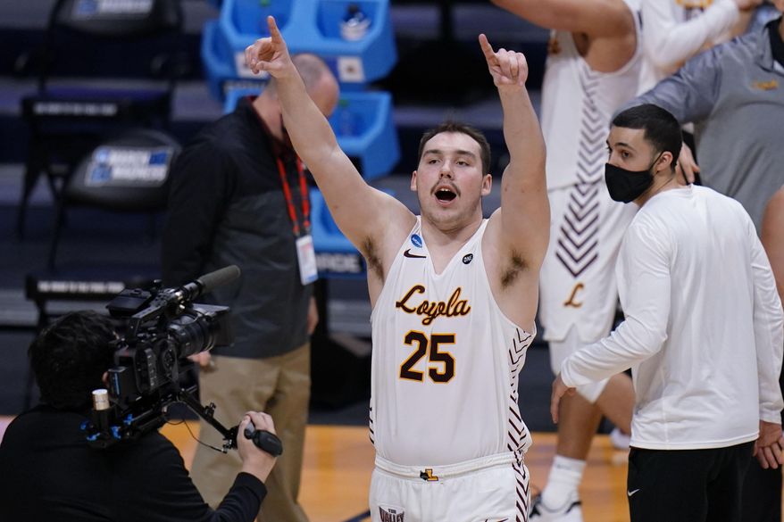 Loyola Chicago center Cameron Krutwig (25) celebrates after defeating Georgia Tech 71-60 in a first-round game in the NCAA men's college basketball tournament at Hinkle Fieldhouse, Indianapolis, Friday, March 19, 2021. (AP Photo/AJ Mast)