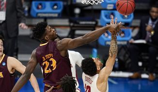 Iona forward Nelly Junior Joseph (23) blocks the shot of Alabama guard Jahvon Quinerly (13) in the first half of a first-round game in the NCAA men&#39;s college basketball tournament at Hinkle Fieldhouse in Indianapolis, Saturday, March 20, 2021. (AP Photo/Michael Conroy)