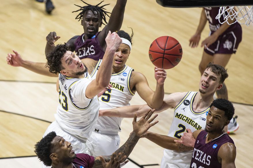 Michigan's Brandon Johns Jr. (23), Terrance Williams II (5), and Franz Wagner (21) compete for a rebound with Texas Southern's Justin Hopkins, left, and Quinton Brigham, right, during the first half of a First Round game in the NCAA men's college basketball tournament, Saturday, March 20, 2021, at Mackey Arena in West Lafayette, Ind. (AP Photo/Robert Franklin)