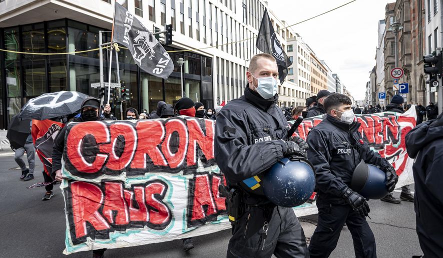 Various initiatives and left-wing groups demonstrate against a demo of right-wing extremists and so-called &amp;quot;Reichsbuerger&amp;quot; in Berlin, Germany, Saturday, March 20, 2021. Right-wing extremists and &amp;quot;Reich citizens&amp;quot; are demonstrating around the Brandenburg Gate today. (Fabian Sommer/dpa via AP)