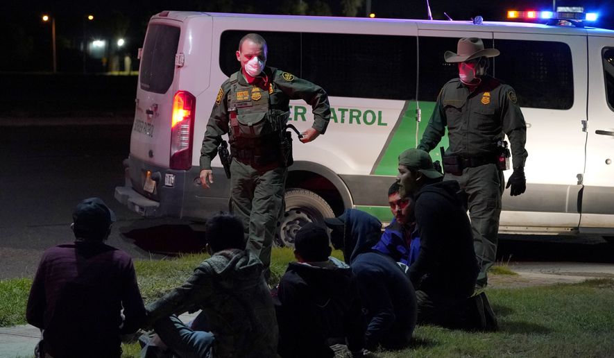 U.S. Customs and Border Protection agents take into custody people near the U.S.-Mexico border, Saturday, March 20, 2021, in Hidalgo, Texas. (AP Photo/Julio Cortez)