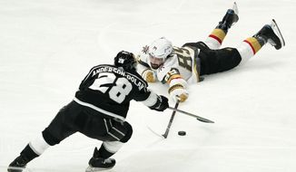 Los Angeles Kings center Jaret Anderson-Dolan, left, and Vegas Golden Knights right wing Alex Tuch go after the puck during the first period of an NHL hockey game Sunday, March 21, 2021, in Los Angeles. (AP Photo/Mark J. Terrill)