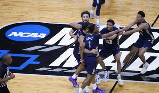 Oral Roberts players celebrate at the end of a college basketball game against Florida in the second round of the NCAA tournament at Indiana Farmers Coliseum, Sunday, March 21, 2021 in Indianapolis. Oral Roberts won 81-78. (AP Photo/AJ Mast) **FILE**