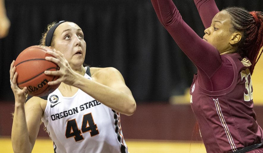 Oregon State&#39;s Taylor Jones (44) looks toward the basket over Florida State forward Valencia Myers (32) during the first half of a college basketball game in the first round of the women&#39;s NCAA tournament at the University Events Center in San Marcos, Texas, Sunday, March 21, 2021. (AP Photo/Stephen Spillman)
