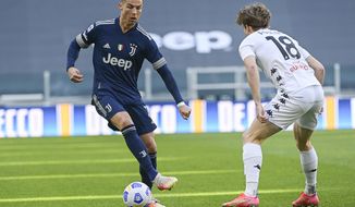Juventus&#39; Cristiano Ronaldo, left, takes on Benevento&#39;s Daam Foulon during the Serie A soccer match between Juventus and Benevento at the Allianz stadium in Turin, Italy, Sunday, March 21, 2021. (Marco Alpozzi/LaPresse via AP)