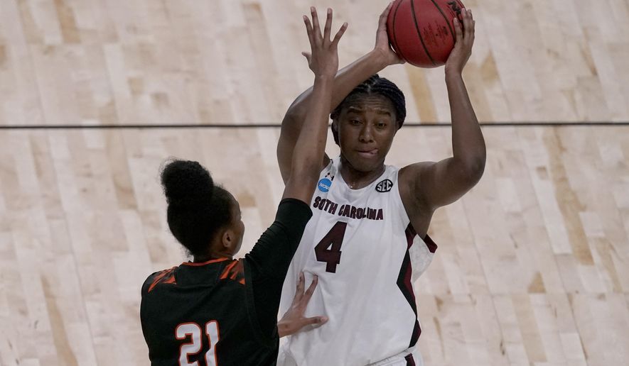 South Carolina forward Aliyah Boston (4) looks to pass under pressure from Mercer guard Shannon Titus (21) during the second half of a college basketball game in the first round of the women&#39;s NCAA tournament at the Alamodome in San Antonio, Sunday, March 21, 2021. (AP Photo/Charlie Riedel)