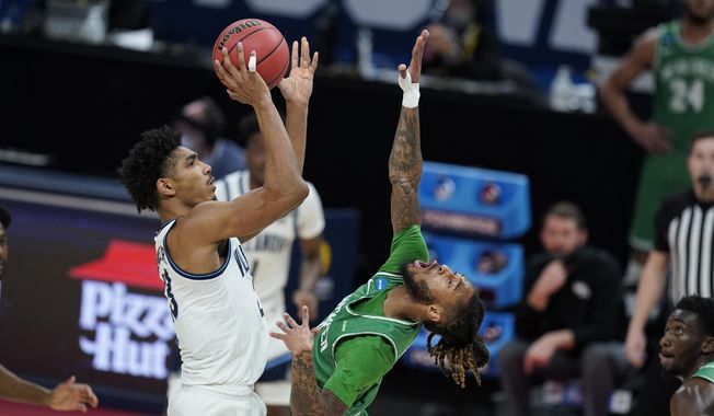 Villanova&#x27;s Jermaine Samuels (23) shoots over North Texas&#x27; James Reese (0) during the first half of a second-round game in the NCAA men&#x27;s college basketball tournament at Bankers Life Fieldhouse, Sunday, March 21, 2021, in Indianapolis. (AP Photo/Darron Cummings)