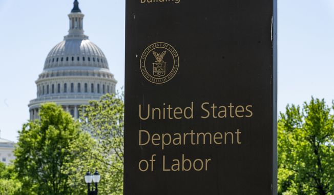 The entrance to the Labor Department is seen near the Capitol in Washington. Unemployment fraud in the U.S. has reached dramatic levels during the pandemic: more than $63 billion has been paid out improperly through fraud or errors since March 2020. Criminals are seizing on the opportunity created by the pandemic and are making false claims using stolen information. (AP Photo/J. Scott Applewhite, File)