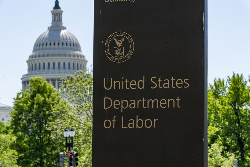 The entrance to the Labor Department is seen near the Capitol in Washington. Unemployment fraud in the U.S. has reached dramatic levels during the pandemic: more than $63 billion has been paid out improperly through fraud or errors since March 2020. Criminals are seizing on the opportunity created by the pandemic and are making false claims using stolen information. (AP Photo/J. Scott Applewhite, File)
