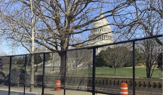 The U.S. Capitol is shown behind security fencing, Sunday, March 21, 2021, in Washington. (AP Photo/Alan Fram)  **FILE**
