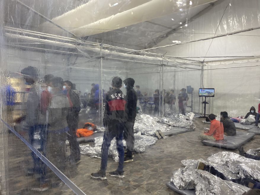 This March 20, 2021, photo provided by the Office of Congressman Henry Cuellar, (TX-28), shows detainees in a Customs and Border Protection (CBP) temporary overflow facility in Donna, Texas. President Joe Biden's administration faces mounting criticism for refusing to allow outside observers into facilities where it is detaining thousands of immigrant children. (Photo courtesy of the Office of Congressman Henry Cuellar via AP)