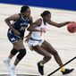 Maryland guard Diamond Miller (1) drives up court ahead of Mount St. Mary&#39;s center Rebecca Lee (34) during the first half of a college basketball game in the first round of the women&#39;s NCAA tournament at the Alamodome in San Antonio, Monday, March 22, 2021. (AP Photo/Eric Gay)