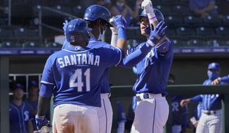 Kansas City Royals&#39; Bobby Witt Jr., right, celebrates his home run with Seuly Matias, center, and Carlos Santana, left, in the fourth inning of a spring training baseball game Monday, March 8, 2021, in Surprise, Ariz. (AP Photo/Sue Ogrocki)
