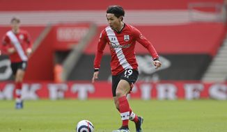 Southampton&#39;s Takumi Minamino controls the ball during an English Premier League soccer match between Southampton and Brighton at the St Mary&#39;s Stadium in Southampton, England, Sunday March 14, 2021. (Mike Hewitt/Pool via AP)