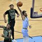 Memphis Grizzlies guard Ja Morant (12) goes up for a dunk against Boston Celtics guard Jeff Teague (55) in the second half of an NBA basketball game Monday, March 22, 2021, in Memphis, Tenn. (AP Photo/Brandon Dill)