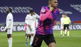Paris Saint Germain&#39;s Kylian Mbappe celebrates after he scored a goal against Lyon during the French League One soccer match between Lyon and PSG in Decines, near Lyon, central France, Sunday, March 21, 2021. (AP Photo/Laurent Cipriani)