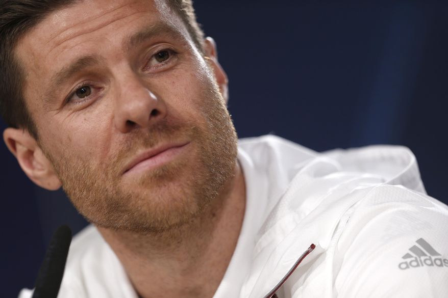 FILE - In this April 17, 2017 file photo, Bayern Munich&#39;s Xabi Alonso listens to a question during a news conference at the Santiago Bernabeu stadium in Madrid, Spain. German media reports say that former Spain midfielder Xabi Alonso is to take over at Borussia Moenchengladbach coach next season. The tabloid Bild and its sister magazine Sport Bild first reported that the 39-year-old Alonso has agreed to take over from current Gladbach coach Marco Rose, who is joining Borussia Dortmund next season. (AP Photo/Francisco Seco, File)