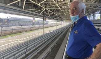 FILE - Roger Penske looks over the track from the grandstand at Indianapolis Motor Speedway in Indianapolis, in this Thursday, July 2, 2020, file photo. There will be fans at this year&#x27;s Indianapolis 500, Penske said Monday, March 22, 2021, but how many remains a moving target based on pandemic restrictions. Penske said more than 170,000 tickets have already been sold for the May 30 race. His first Indy 500 as owner of the historic property ran in front of empty grandstands last year.  (AP Photo/Jenna Fryer, File)