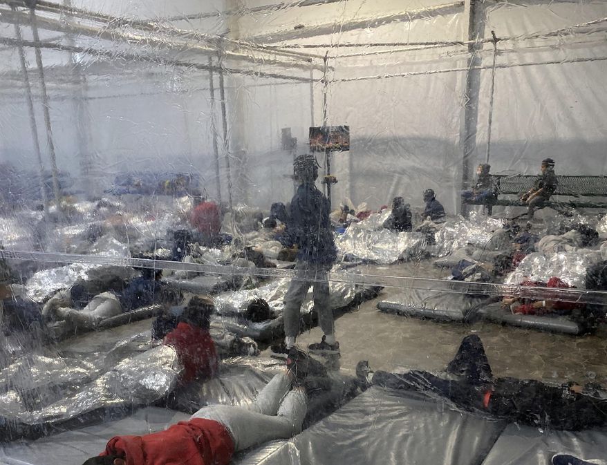 This March 20, 2021, photo provided by the Office of Rep. Henry Cuellar, D-Texas, shows detainees in a Customs and Border Protection (CBP) temporary overflow facility in Donna, Texas. President Joe Biden&#39;s administration faces mounting criticism for refusing to allow outside observers into facilities where it is detaining thousands of immigrant children.  (Photo courtesy of the Office of Rep. Henry Cuellar via AP)
