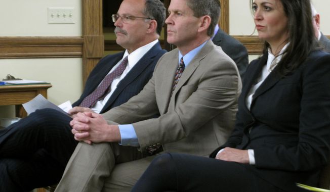 FILE - In this Nov. 13, 2018 file photo, then-Montana Secretary of State Corey Stapleton is flanked by his elections director Dana Corson and then-deputy secretary Christi Jacobsen, as they wait to testify before a legislative committee in Helena, Mont. Jacobsen, a Republican and now the secretary of state, has requested legislation that would allow anyone to bring forward a petition to gather signatures and qualify a minor party for the ballot, even if they were not affiliated with the party. (AP Photo/Matt Volz,File)