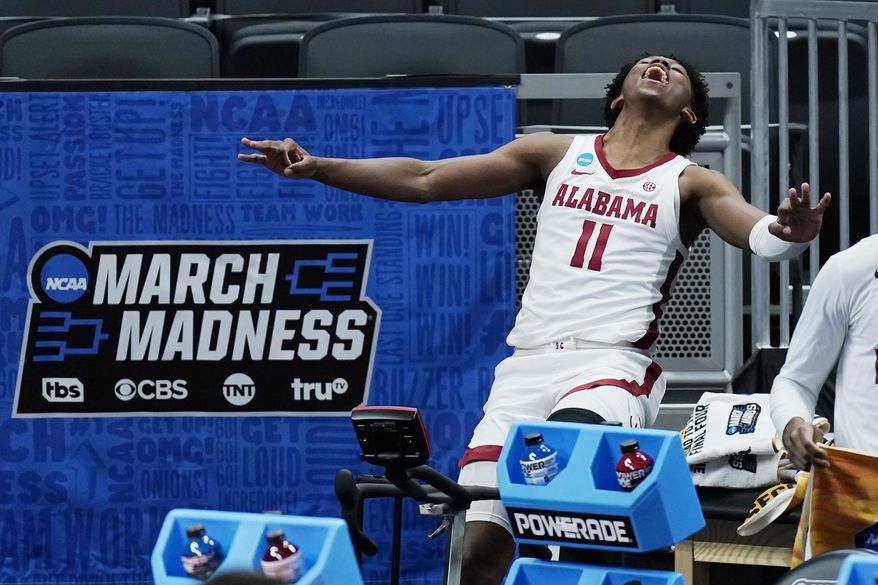 Alabama&#39;s Joshua Primo celebrates a teammate&#39;s score against Maryland during the second half of a college basketball game in the second round of the NCAA tournament at Bankers Life Fieldhouse in Indianapolis Monday, March 22, 2021. (AP Photo/Mark Humphrey)