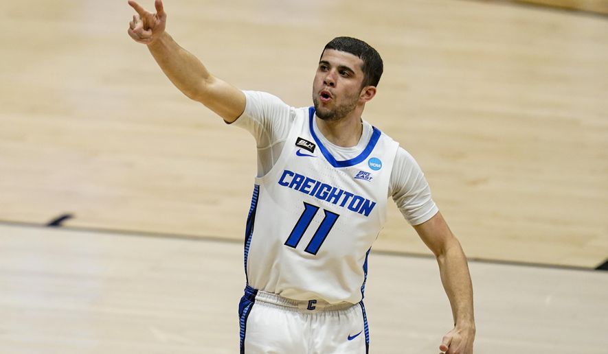 Creighton guard Marcus Zegarowski (11) celebrates a three-point basket against Ohio in the first half of a second-round game in the NCAA men&#39;s college basketball tournament at Hinkle Fieldhouse in Indianapolis, Monday, March 22, 2021. (AP Photo/Michael Conroy)