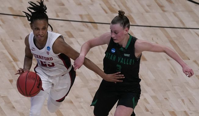 Stanford guard Kiana Williams drives under pressure from Utah Valley guard Maria Carvalho (3) during the second half of a college basketball game in the first round of the women&#x27;s NCAA tournament at the Alamodome in San Antonio, Sunday, March 21, 2021. (AP Photo/Charlie Riedel)