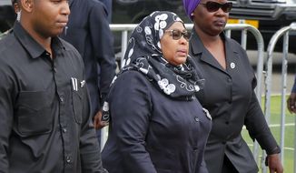 Tanzania&#39;s new President Samia Suluhu Hassan, center, arrives to pay her respects as the body of former president John Magufuli lies in state at Uhuru stadium in Dar es Salaam, Tanzania Saturday, March 20, 2021. Magufuli, a prominent COVID-19 skeptic whose populist rule often cast his country in a harsh international spotlight, died Wednesday aged 61 of heart failure, it was announced by Vice President Samia Suluhu Hassan, who was sworn-in as the country&#39;s new president on Friday. (AP Photo)