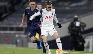 Tottenham&#x27;s Gareth Bale controls the ball in front of Dinamo Zagreb&#x27;s Rasmus Lauritsen, left, during the Europa League round of 16, first leg, soccer match between Tottenham Hotspur and Dinamo Zagreb at the Tottenham Hotspur Stadium in London, England, Thursday, March 11, 2021. (AP photo/Alastair Grant, Pool)