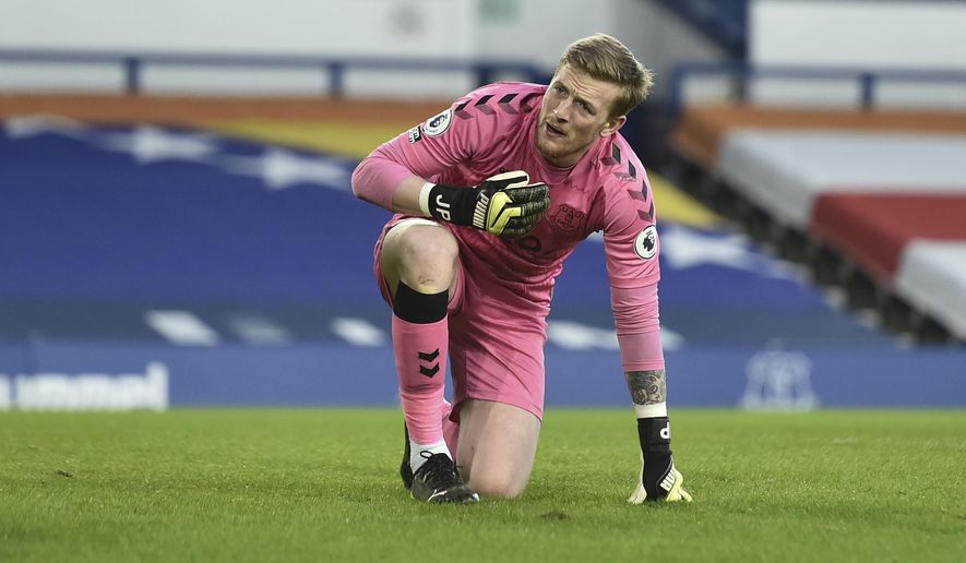 Everton&#39;s goalkeeper Jordan Pickford reacts after sustaining an injury during the English Premier League soccer match between Everton and Burnley at Goodison Park in Liverpool, England, Saturday, March 13, 2021. (Peter Powell/Pool via AP)