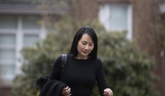 Meng Wanzhou, the chief financial officer of Huawei, leaves her home to attend a hearing at British Columbia Supreme Court in Vancouver, British Columbia on Tuesday, March 23, 2021. (Darryl Dyck/The Canadian Press via AP)