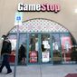 FILE - In this Jan. 28, 2021 file photo, a pedestrian passes a GameStop storefront in Dallas. A hefty tax benefit helped drive GameStop’s fiscal fourth-quarter profit sharply higher, but the video-game retailer’s sales declined despite a surge in its online business. The company&#39;s latest results fell short of Wall Street’s expectations. (AP Photo/LM Otero, File)