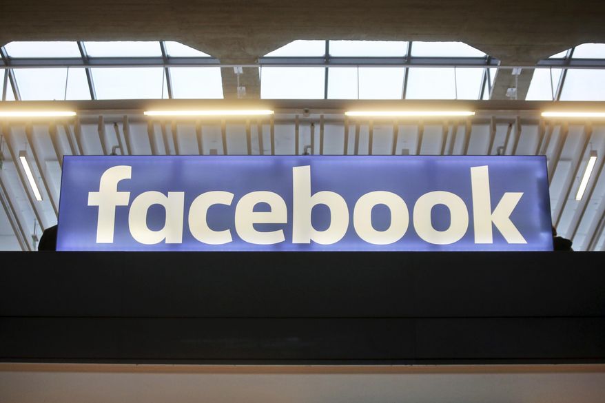 FILE - In this Tuesday, Jan. 17, 2017, file photo, the Facebook logo is displayed at a gathering for startup companies at Paris' Station F. Facebook has allowed groups, many tied to QAnon and militia movements, to glorify violence during the 2020 election, a new report has found. (AP Photo/Thibault Camus, File)