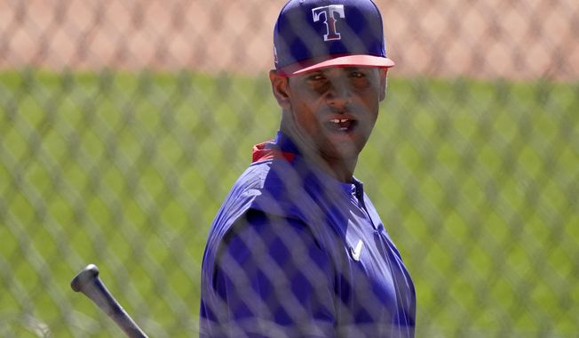 Texas Rangers&#x27; Khris Davis waits to bat during spring training baseball practice Monday, Feb. 22, 2021, in Surprise, Ariz. (AP Photo/Charlie Riedel)